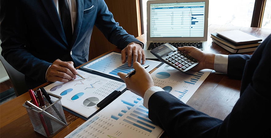 Accountant reviewing financial reports and calculations with a client in Charleston, SC.